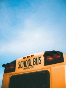 Decorative image of th eback of a school bus against blue sky